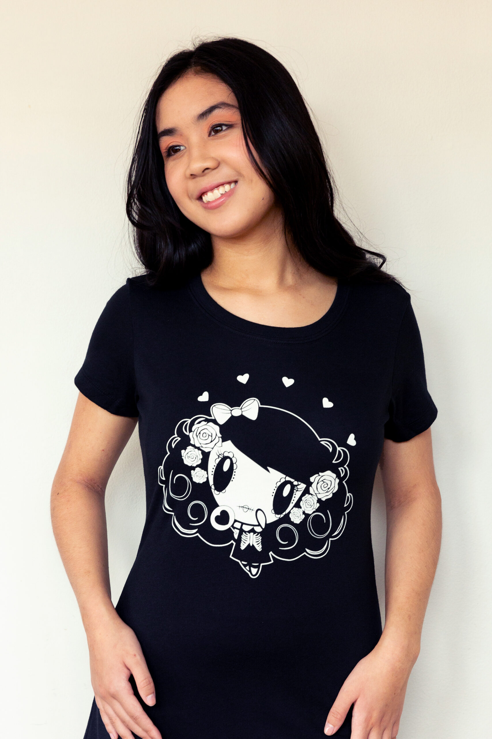 A girl smiling wearing a Lolligag Day of the Dead shirt