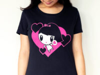 A girl looking at the graphic of her Dancing Hearts Lolligag Tee