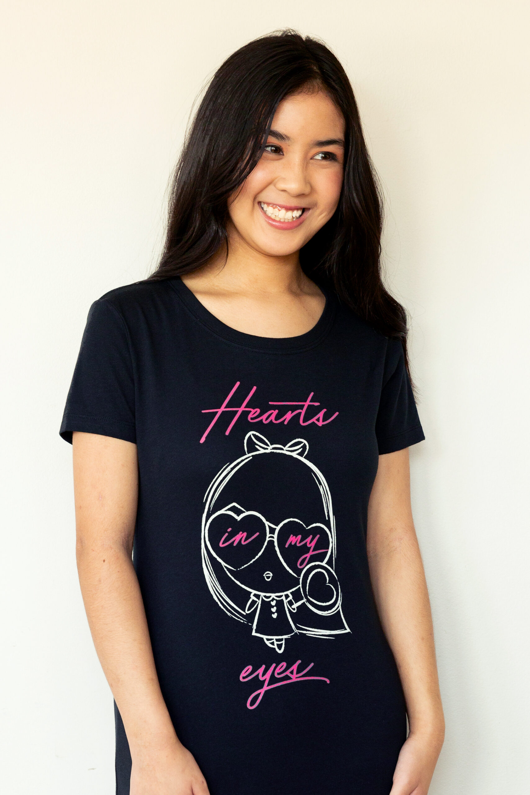 A girl laughing wearing the Dancing Hearts Lolligag Tee