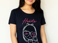 A girl wearing the Dancing Hearts Lolligag Tee