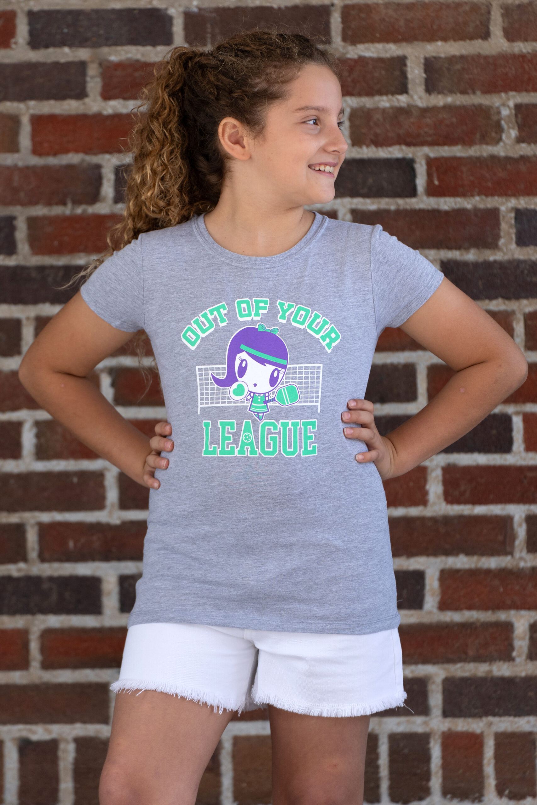 Girl wearing the Out of Your League Lolligag kids tee