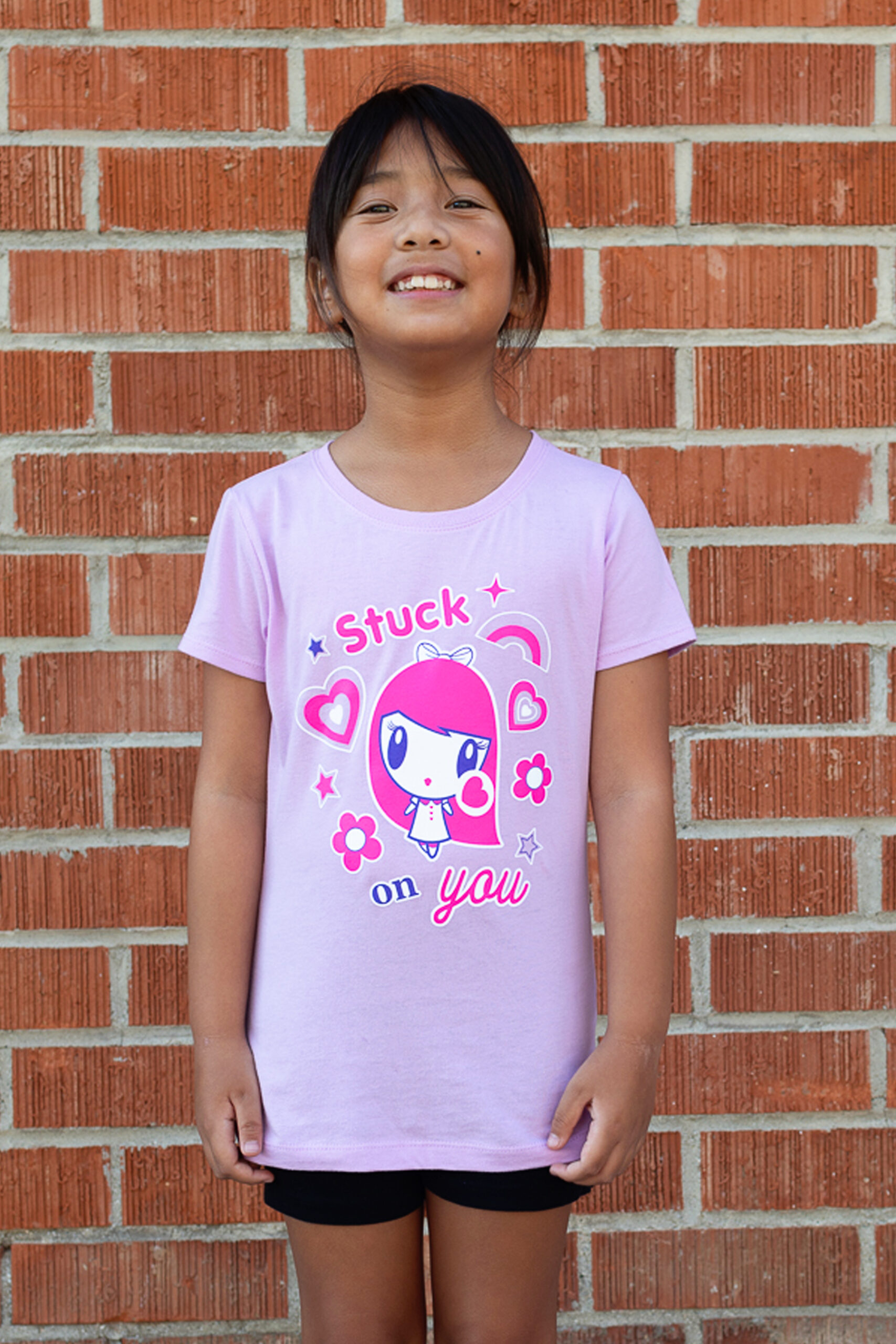 Girl smiling wearing the Stuck on You Lolligag tee