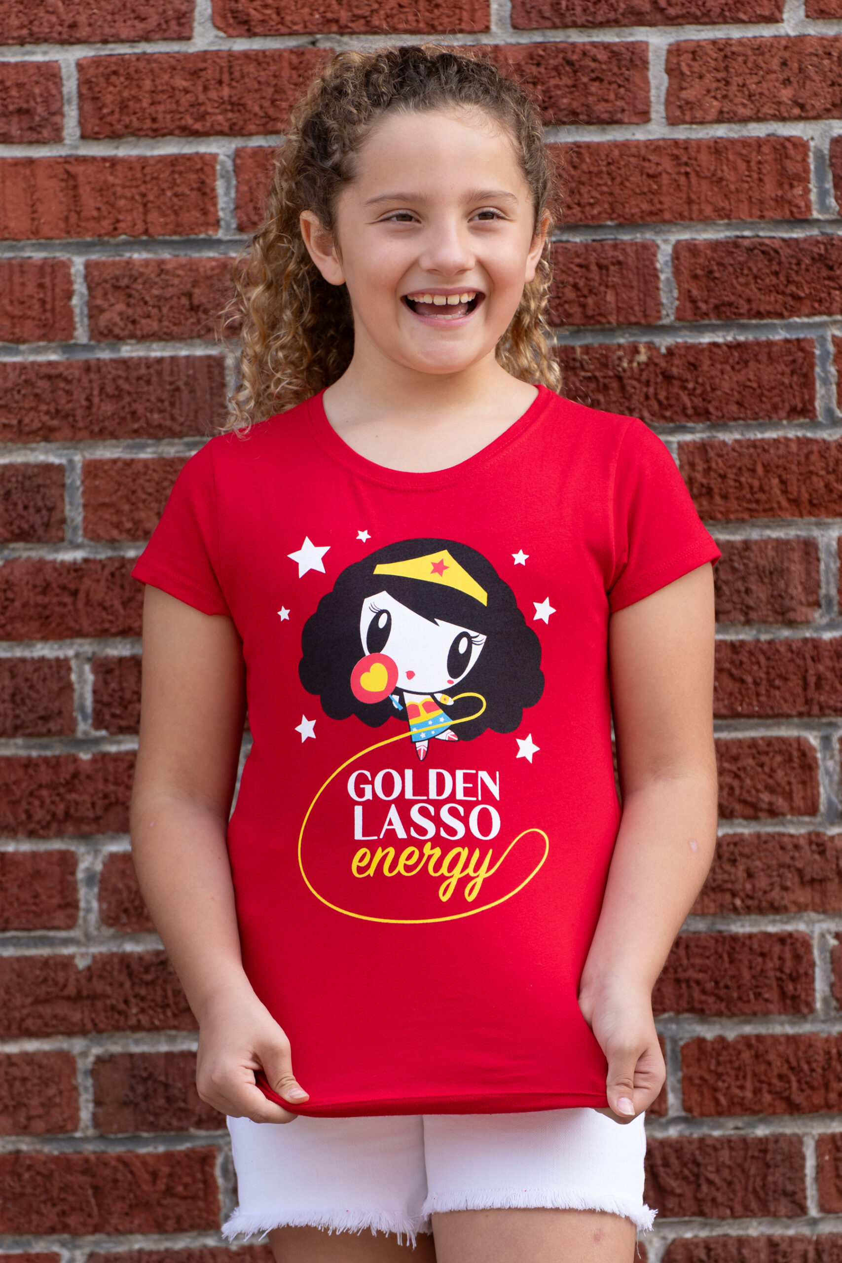 Girl wearing the Golden Lasso Energy Lolligag kids tee