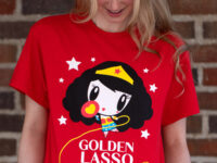 Young adult wearing the Lolligag Golden Lasso Energy Tee