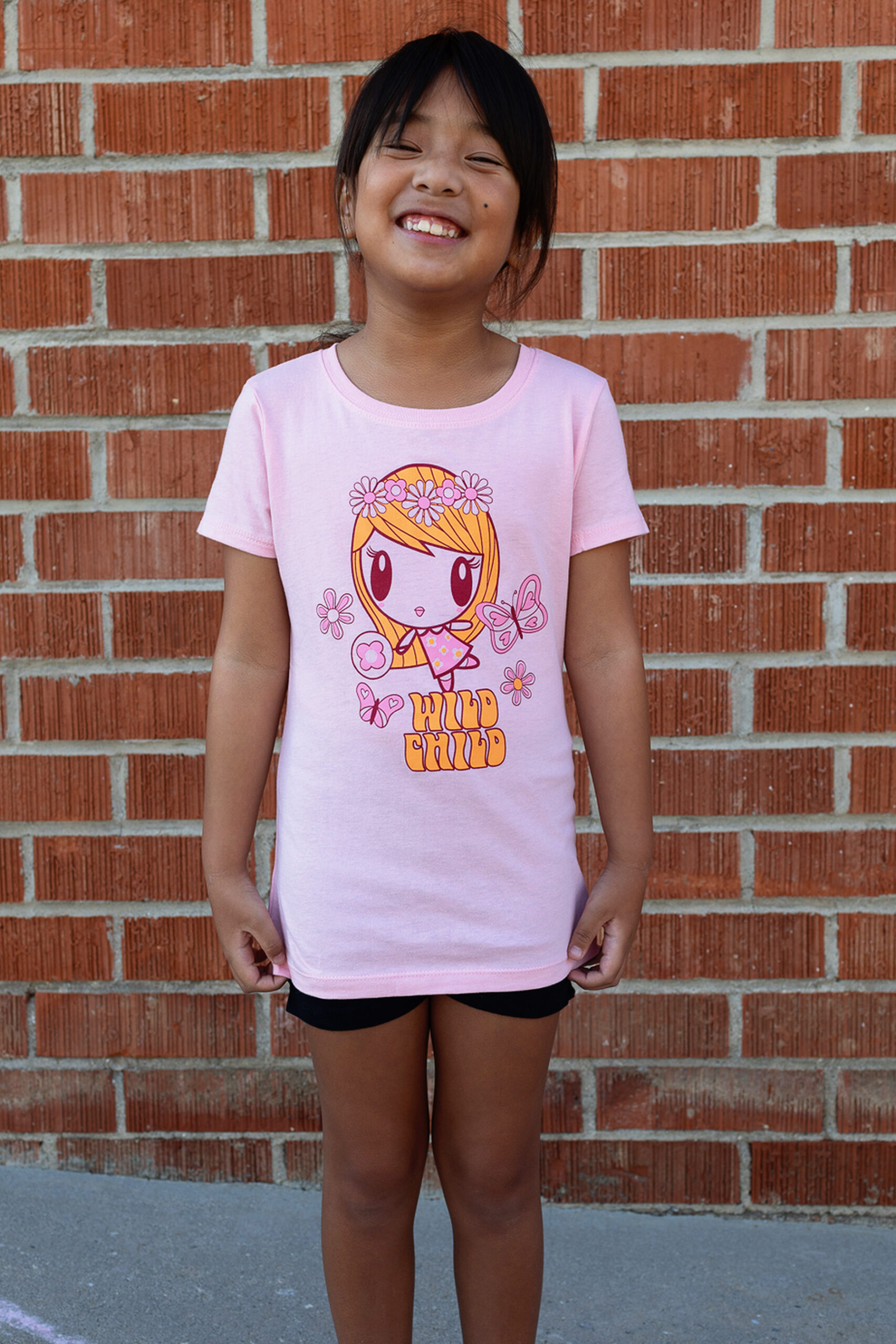 Girl wearing the Wild Child Lolligag Tee