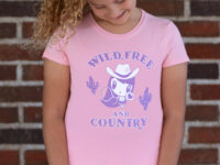 Girl wearing the Lolligag Wild, Free and Country Kids T shirt