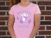 Girl wearing the Wild, Free and Country Lolligag Kids tee